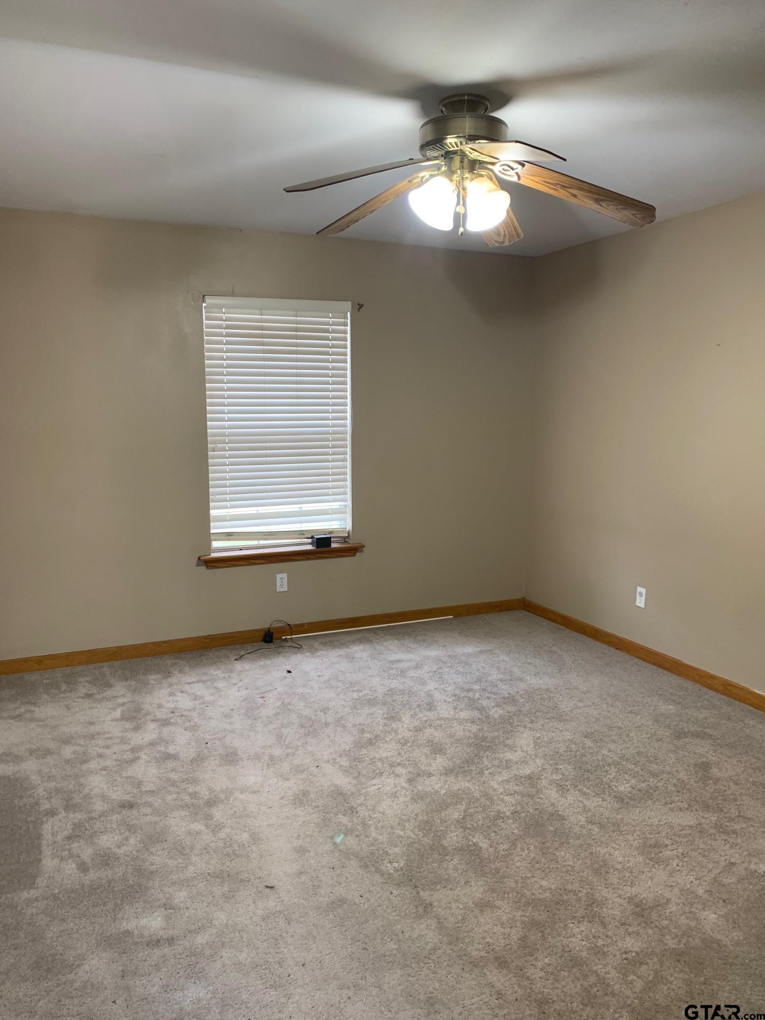 120 Rscr 3340 Emory, TX 75440 - Photo 5 of 21 an empty room with a chandelier fan and window