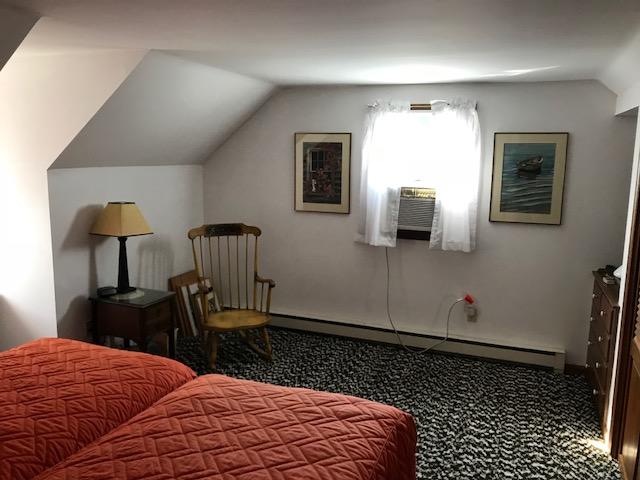 29 Schooner Road Dennis, MA 02638 - Photo 12 of 32 a bedroom with a bed and wooden floor