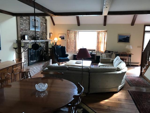 29 Schooner Road Dennis, MA 02638 - Photo 17 of 32 a living room with furniture a window and gym equipment