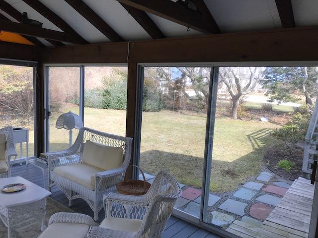 29 Schooner Road Dennis, MA 02638 - Photo 18 of 32 a living room with a floor to ceiling window and wooden floor