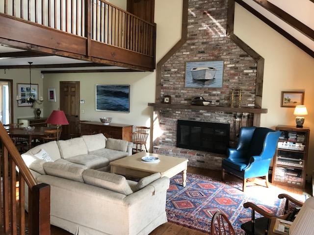 29 Schooner Road Dennis, MA 02638 - Photo 22 of 32 a living room with furniture a fireplace and a flat screen tv