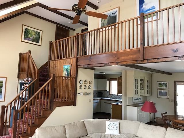 29 Schooner Road Dennis, MA 02638 - Photo 24 of 32 a kitchen with stainless steel appliances kitchen island granite countertop a refrigerator a stove and a dining table with wooden floor