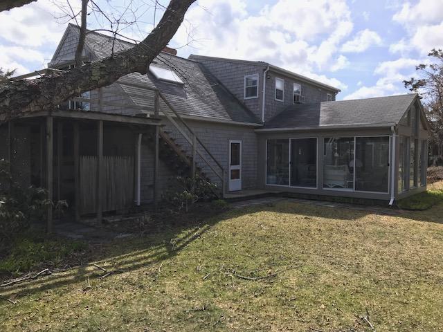 29 Schooner Road Dennis, MA 02638 - Photo 26 of 32 a front view of a house with a yard and garage