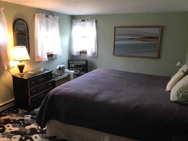 29 Schooner Road Dennis, MA 02638 - Photo 7 of 32 a bedroom with a bed and a dresser next to a window