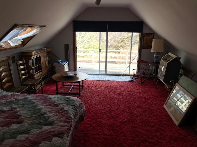 29 Schooner Road Dennis, MA 02638 - Photo 8 of 32 a bed sitting in a bedroom next to a window