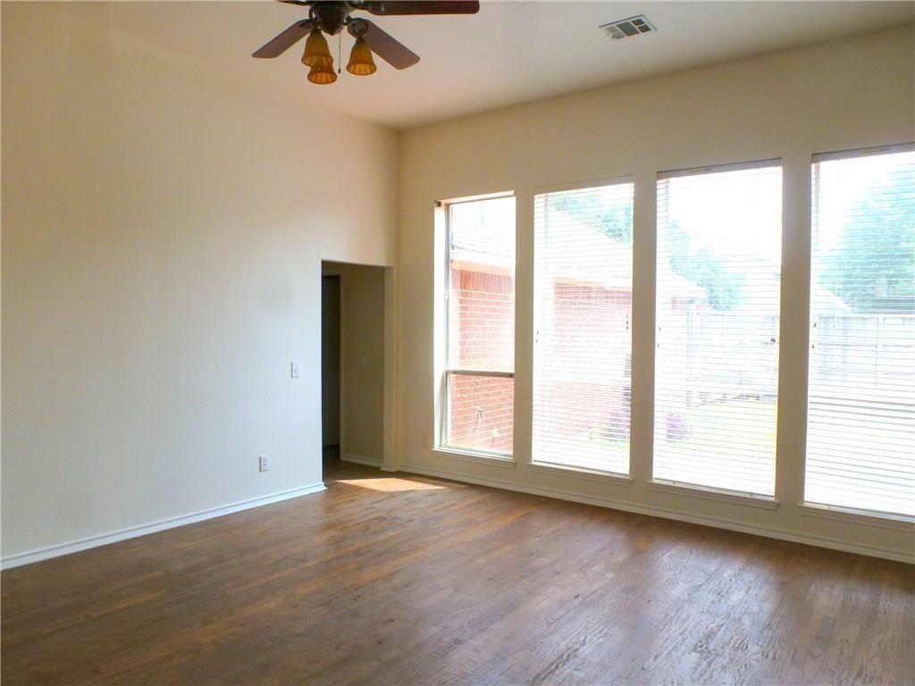9911 Max Lane Frisco, TX 75035 - Photo 11 of 16 a view of an empty room with a window and wooden floor