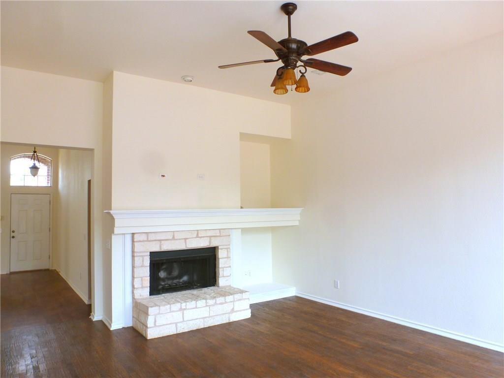9911 Max Lane Frisco, TX 75035 - Photo 12 of 16 an empty room with a fireplace and wooden floor