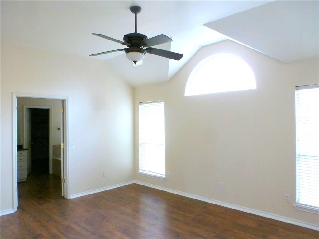 9911 Max Lane Frisco, TX 75035 - Photo 15 of 16 an empty room with wooden floor fan and windows