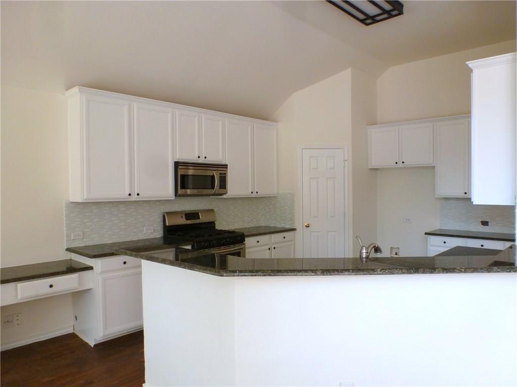 9911 Max Lane Frisco, TX 75035 - Photo 2 of 16 a kitchen with stainless steel appliances granite countertop a stove a sink and a refrigerator