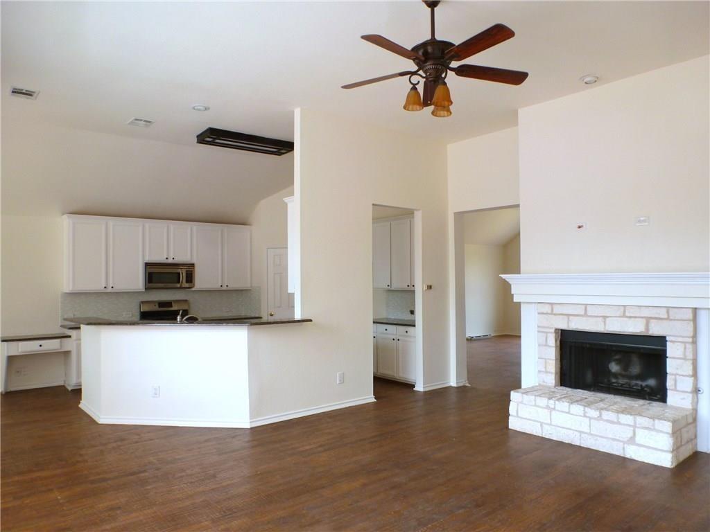 9911 Max Lane Frisco, TX 75035 - Photo 3 of 16 a kitchen with stainless steel appliances a stove top oven a refrigerator and a fireplace
