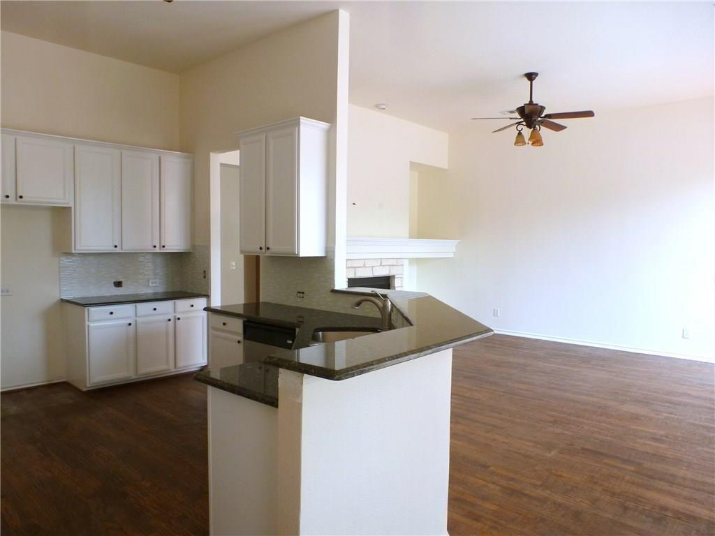 9911 Max Lane Frisco, TX 75035 - Photo 4 of 16 a kitchen with a stove a sink and a refrigerator