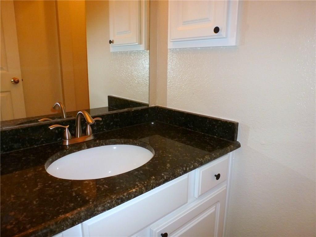 9911 Max Lane Frisco, TX 75035 - Photo 5 of 16 a bathroom with a granite countertop sink and a mirror