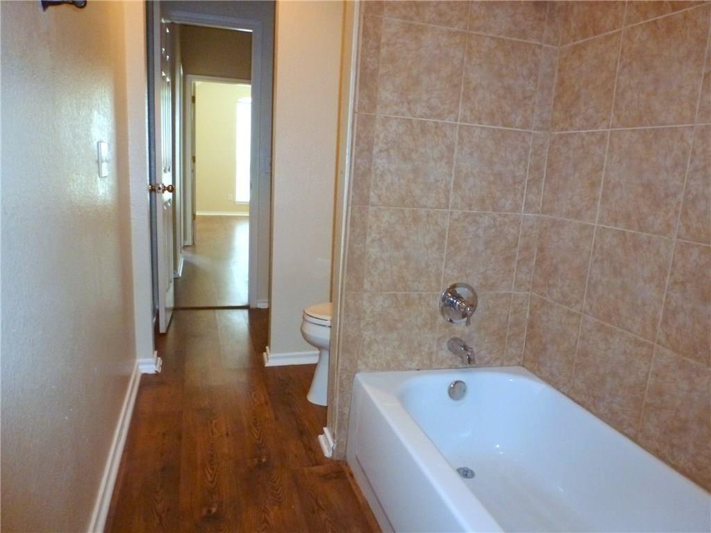 9911 Max Lane Frisco, TX 75035 - Photo 6 of 16 a bathroom with a tub a toilet and a sink