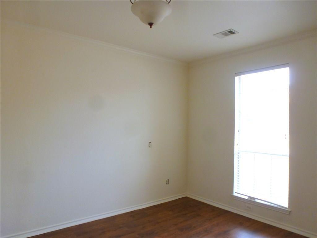 9911 Max Lane Frisco, TX 75035 - Photo 8 of 16 an empty room with wooden floor and windows