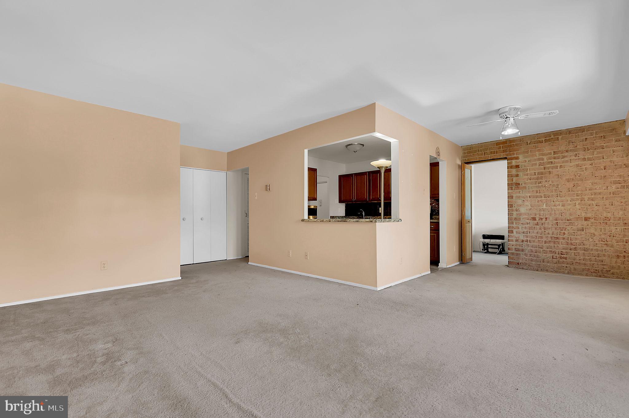19309 Club House Road, Unit 19309 Gaithersburg, MD 20886 - Photo 11 of 24 a view of a livingroom with an empty space and a kitchen