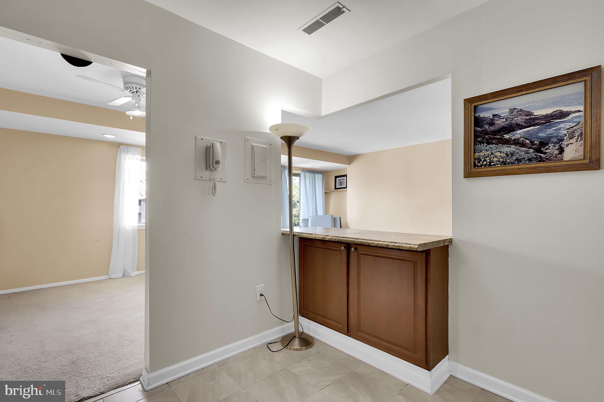 19309 Club House Road, Unit 19309 Gaithersburg, MD 20886 - Photo 4 of 24 a view of a hallway with paintings on the wall