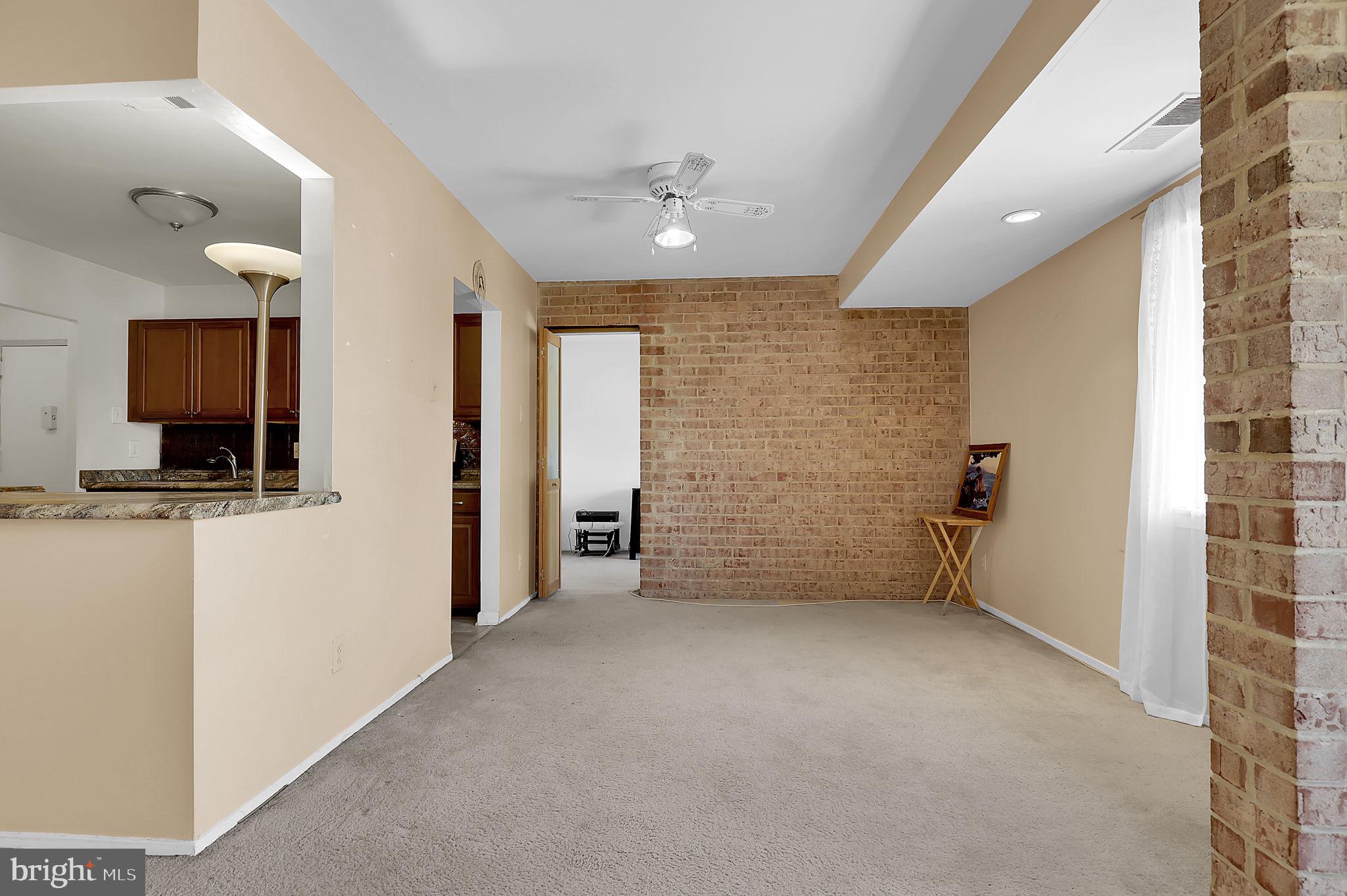 19309 Club House Road, Unit 19309 Gaithersburg, MD 20886 - Photo 9 of 24 a view of a livingroom with an empty space and a hallway