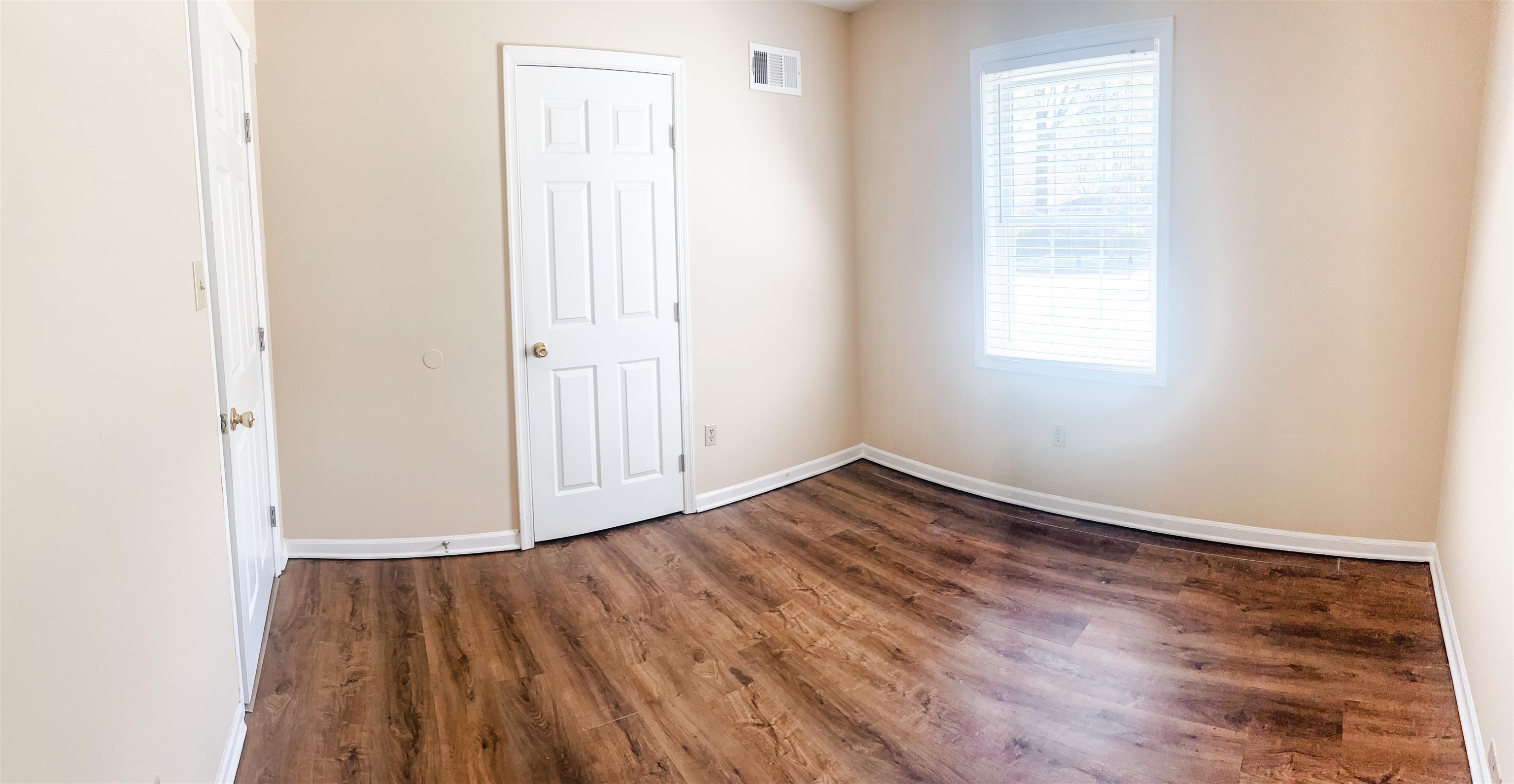 520 Jeffrey Lane Collierville, TN 38017 - Photo 8 of 11 Unfurnished room featuring wood finished floors, baseboards, and visible vents