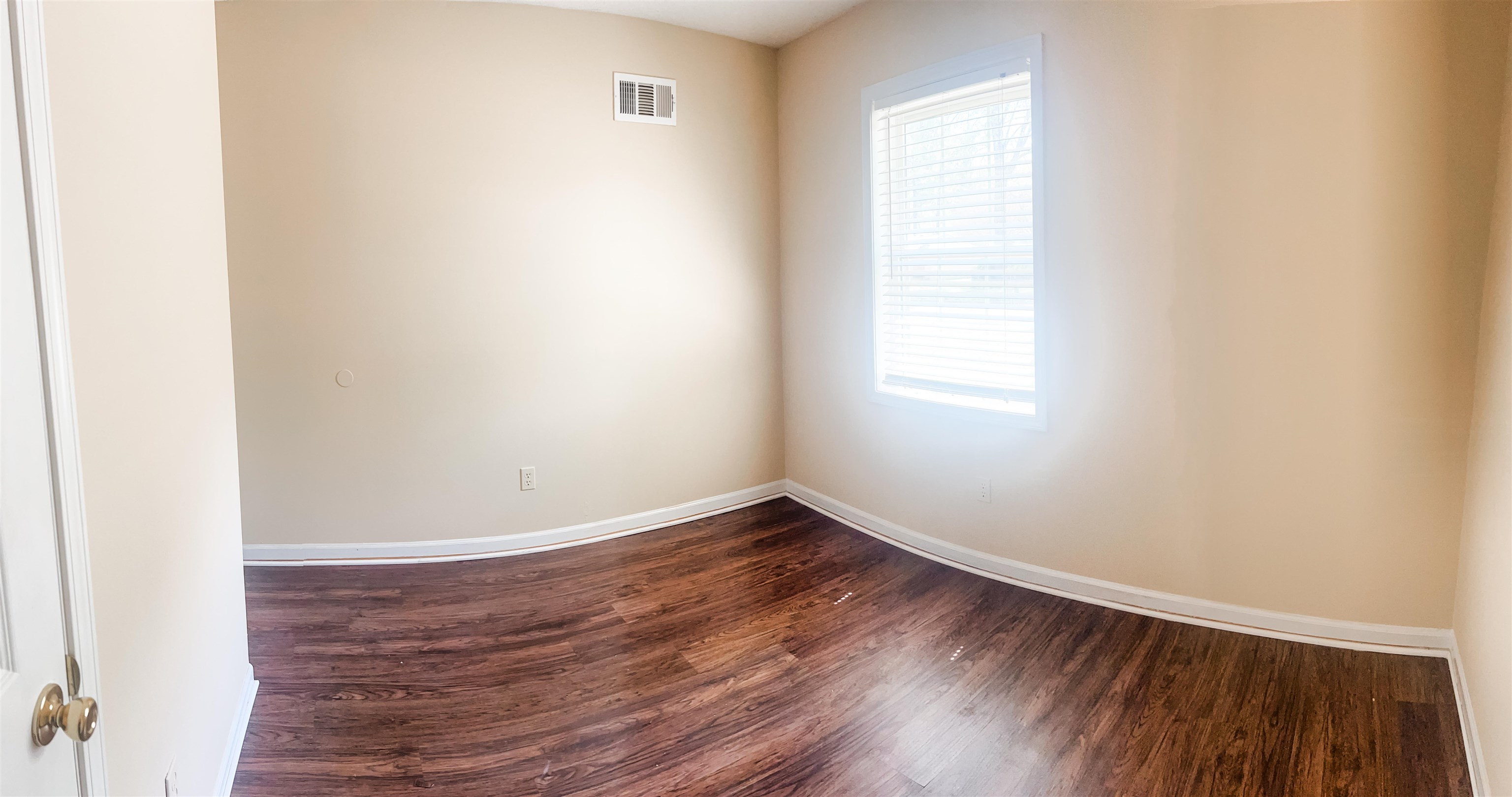 520 Jeffrey Lane Collierville, TN 38017 - Photo 9 of 11 Empty room featuring dark wood-type flooring, visible vents, and baseboards