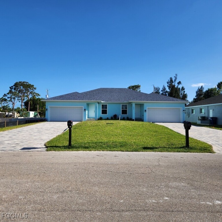 a front view of a house with a yard and garage