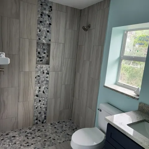a bathroom with a sink a toilet and shower curtain