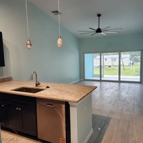 a bathroom with a granite countertop sink a toilet and a large mirror