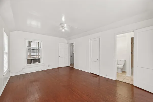 an empty room with a bathroom and a toilet