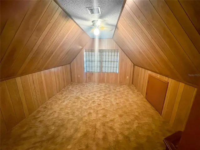 a view of a porch with furniture and garden
