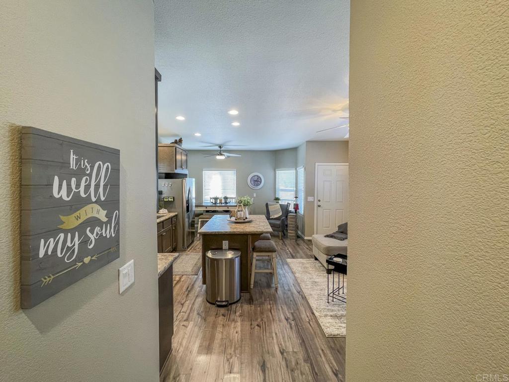 8545 Mission Gorge Road, Unit SPC 211 Santee, CA 92071 - Photo 16 of 33 a view of a room with kitchen island stainless steel appliances wooden floor and living room view