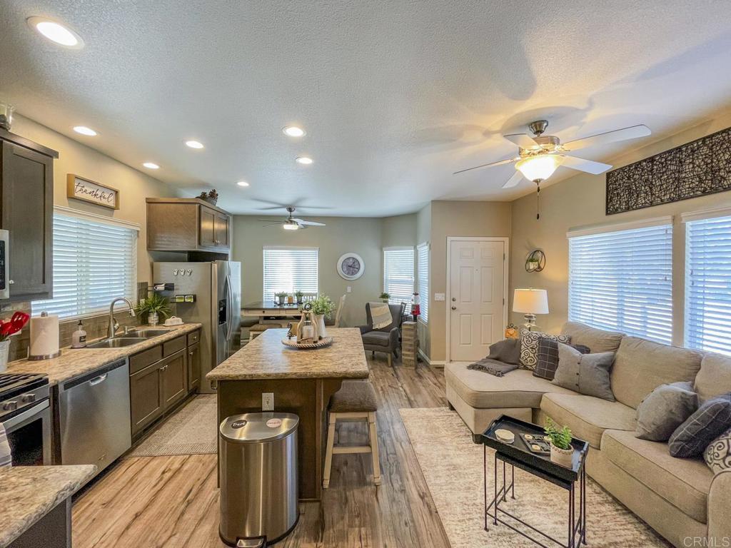 8545 Mission Gorge Road, Unit SPC 211 Santee, CA 92071 - Photo 17 of 33 a living room with furniture a dining table and kitchen view