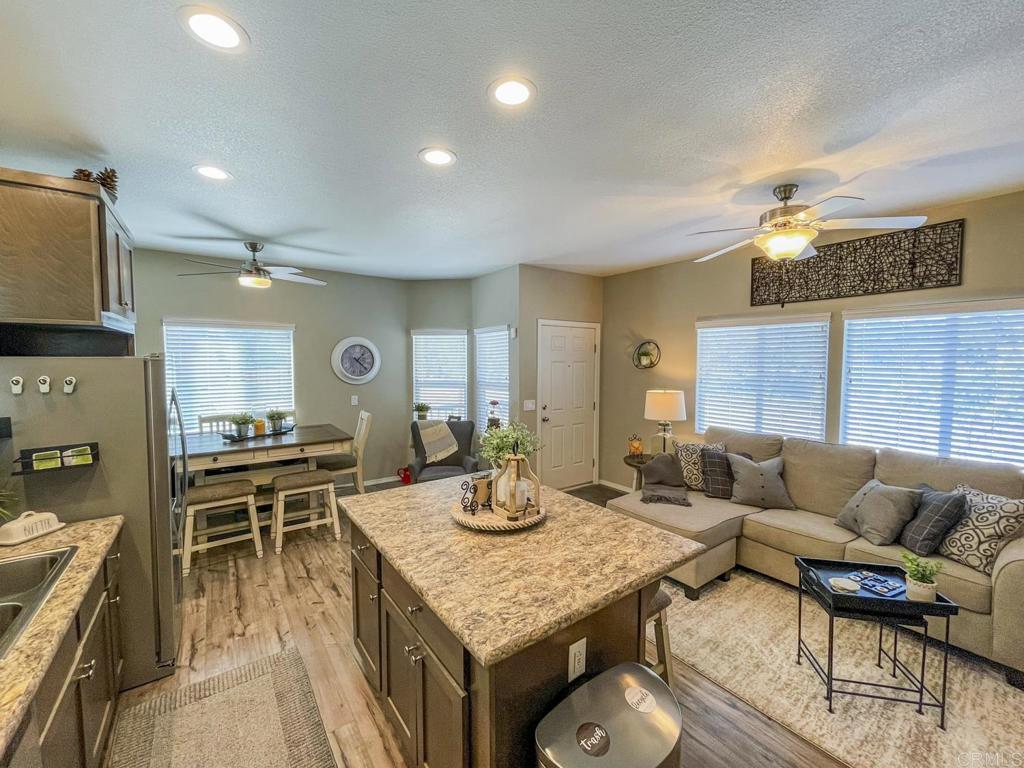 8545 Mission Gorge Road, Unit SPC 211 Santee, CA 92071 - Photo 18 of 33 a living room with fireplace furniture and a wooden floor