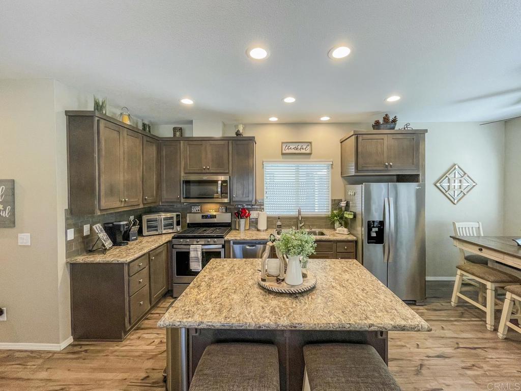 8545 Mission Gorge Road, Unit SPC 211 Santee, CA 92071 - Photo 19 of 33 a kitchen with a table chairs and refrigerator