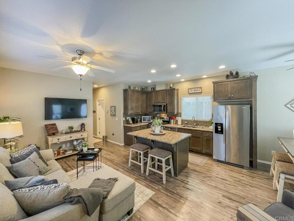 8545 Mission Gorge Road, Unit SPC 211 Santee, CA 92071 - Photo 22 of 33 a living room with furniture a fireplace and a flat screen tv