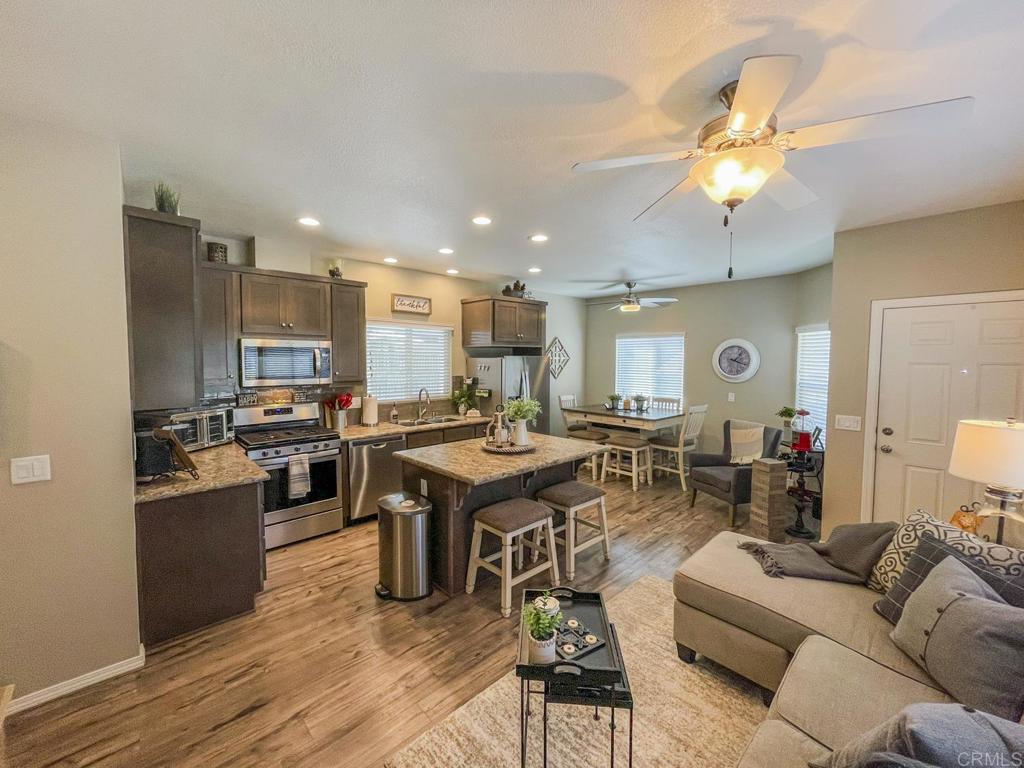8545 Mission Gorge Road, Unit SPC 211 Santee, CA 92071 - Photo 23 of 33 a living room with lots of furniture kitchen view and a wooden floor