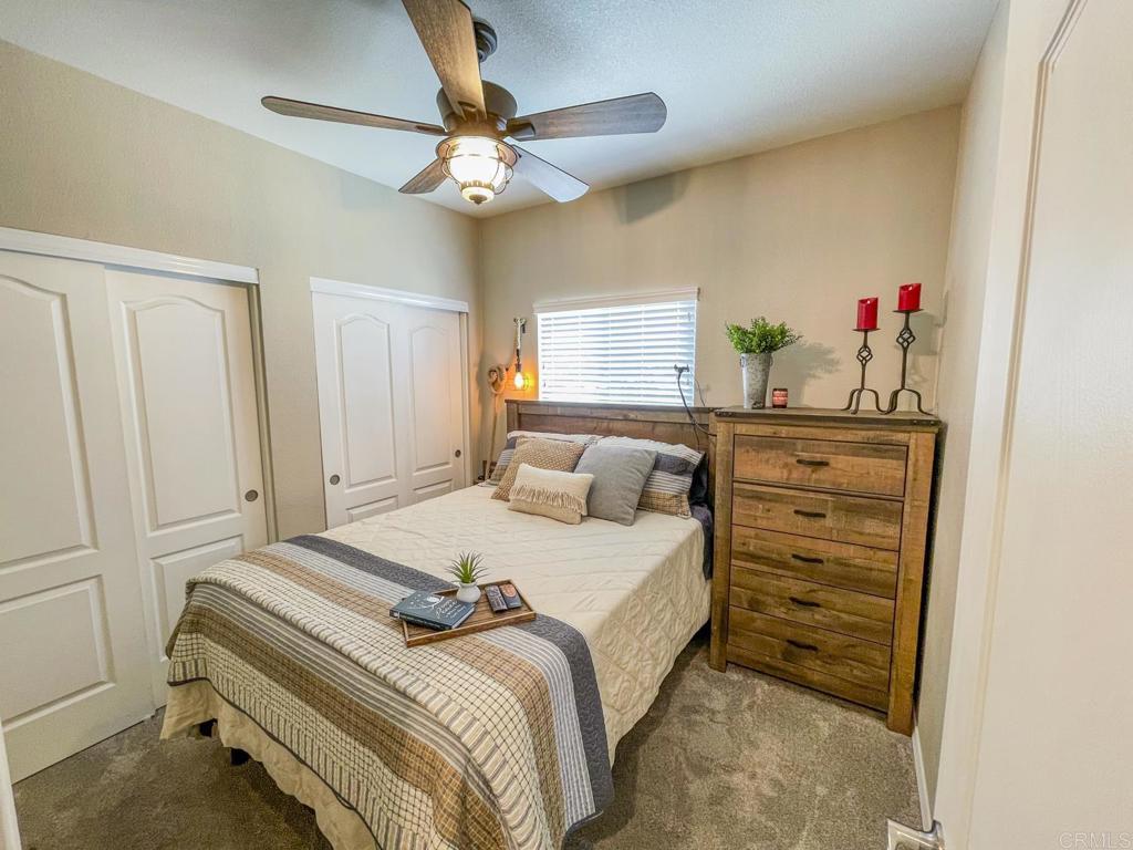 8545 Mission Gorge Road, Unit SPC 211 Santee, CA 92071 - Photo 8 of 33 a bedroom with a bed and a chandelier