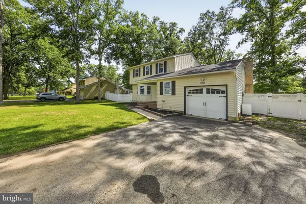 a view of a house with a yard and garage
