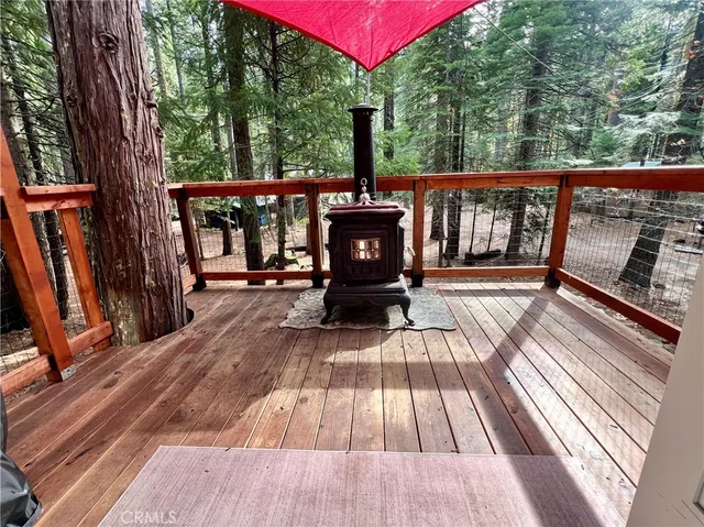 a view of balcony with wooden floor and outdoor seating
