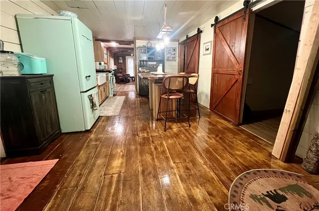 a view of a kitchen with furniture and wooden floor