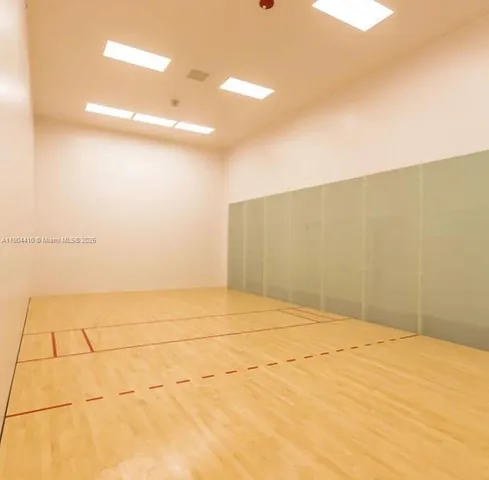 a large white kitchen with a large window