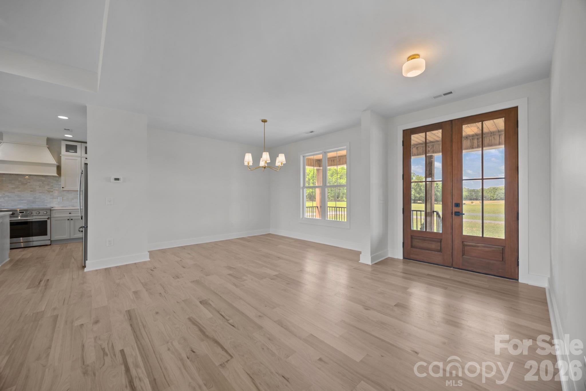 4805 Patterson Road China Grove, NC 28023 - Photo 13 of 42 an empty room with windows and wooden floor