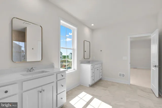 a spacious bathroom with a double vanity sink mirror and double