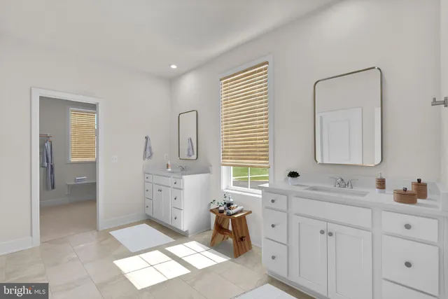 a large white kitchen with a sink a window and stainless steel appliances
