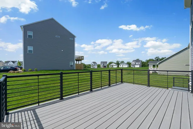 a view of a deck with wooden floor and fence