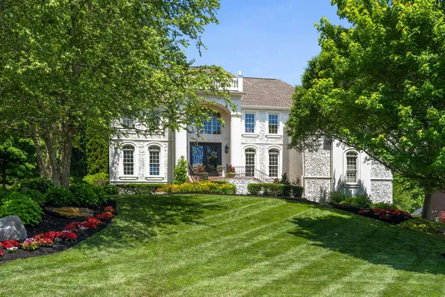 a front view of a house with a yard table and chairs