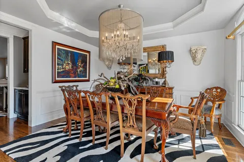 a view of a dining room with furniture and wooden floor