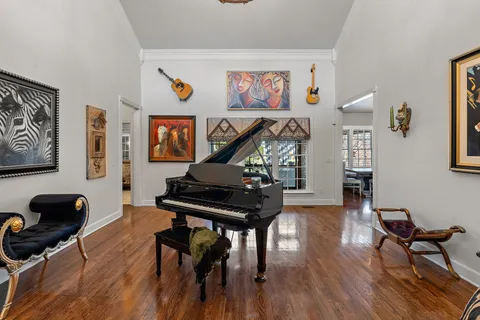 a living room with furniture and a piano