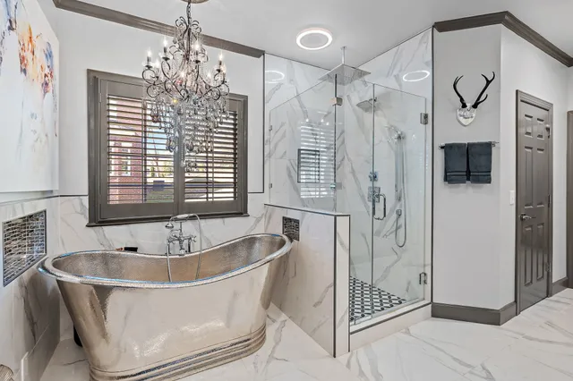 a spacious bathroom with a tub sink shower and mirror