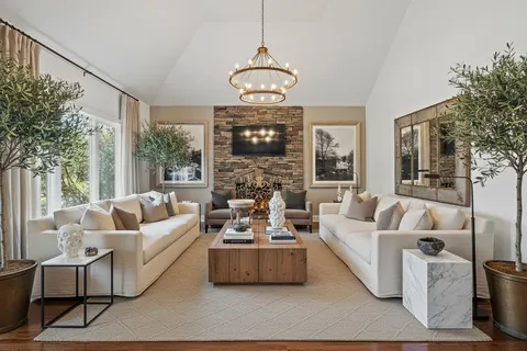 a living room with furniture and a chandelier
