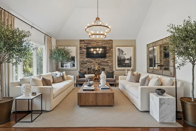 a living room with furniture and a chandelier