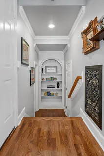 a view of a livingroom with wooden floor and furniture